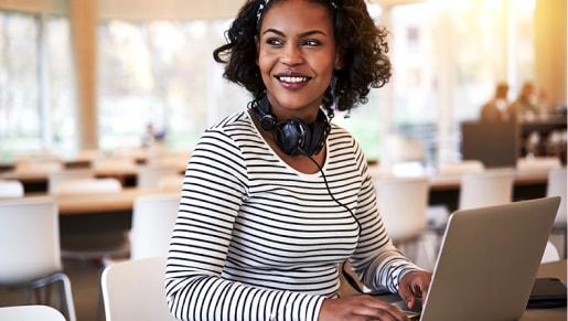 Woman smiling and working on laptop