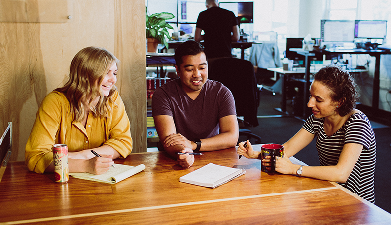 Three Optimal team members take part in a planning meeting.