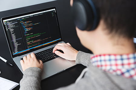 person coding on laptop