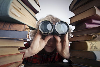 student looking through binoculars